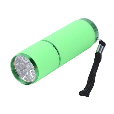 Green flashlight with a black strap on a white background