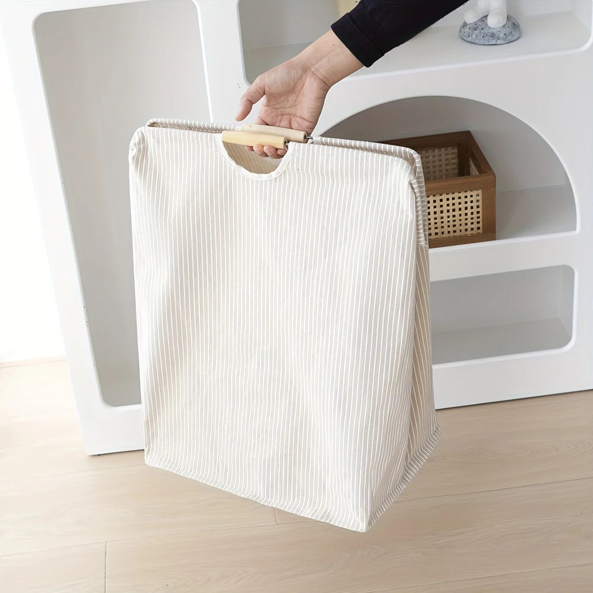 Laundry hamper featuring dual handles for easy transport and efficient home organization.