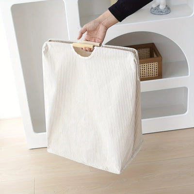 Laundry hamper featuring dual handles for easy transport and efficient home organization.