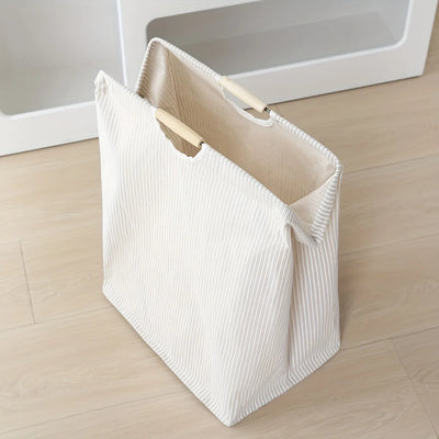 Laundry hamper featuring dual handles for easy transport and efficient home organization.