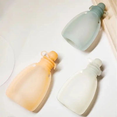 Three colored pouches on a light background