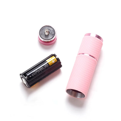 Pink electronic device with battery on a white background