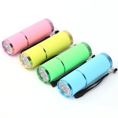 Four colorful flashlights in pink, yellow, green, and blue on a white background